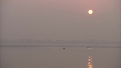 A golden sun casts dusky light over the ocean's horizon. Stock Footage