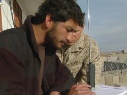 CU ZI National police listening radio and explaining to soldier / Musa Qala, Helmand Province, Afghanistan. Stock Footage