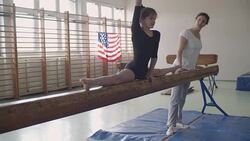 4K: Girl doing split on balance beam Stock Footage