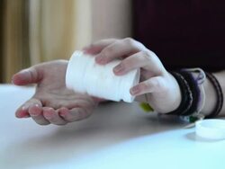 Pouring pills into hands Stock Footage