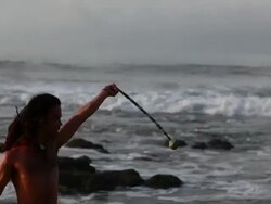 MS TS Rasta man spinninig poi balls with ocean / Montezuma, Punteranes, Costa Rica Stock Footage