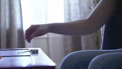 A drug user injects herself with a hypodermic needle. Stock Footage