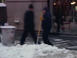 WS PAN Man using snow blower to clear sidewalk in front of business / New York, New York, United States Stock Footage