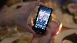 Young man in restaurant takes photo of his food and uses smartphone app to edit it Stock Footage