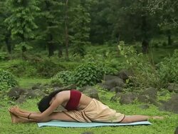 Young woman practicing yoga in the forest, Malshej Ghat, Maharashtra, India Stock Footage