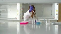 MS Female scientist transferring solution from beaker to centrifuge test tubes with pipettor in research lab Stock Footage