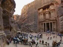 T/L, WS, fish eye, fast moving people outside the Al Khazneh (Treasury) at ancient stone city of Petra / Jordan Stock Footage