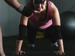 woman doing push ups in a gym Stock Footage