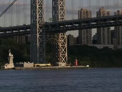 A tugboat pushed a barge under the George Washington Bridge Stock Footage
