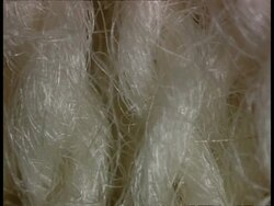 ECU track right across Wool carpet pile, white Stock Footage