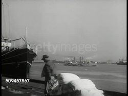1936: NEW ORLEANS SEAPORT: WS New Orleans harbor, dock worker FG. WS Paddlewheel boats, ferries in harbor. Louisiana Instructional Video
