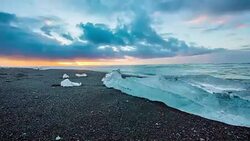 T/L Icebergs on black beach at sunrise Stock Footage