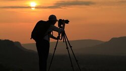 silhouette of women take a photo with mountain at sunset . Stock Footage