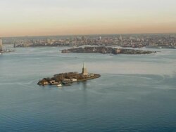 Aerial view of lower Manhattan and Statue of Liberty in the late afternoon Stock Footage