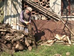 HD: Old Man Axing Wood Stock Footage