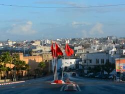 Rabat Morocco traffic outdoors on road in city center with flags Stock Footage