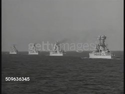 1940: US FLEET: US Flag flying on ship. WS US Navy fleet cruisers ships on ocean. MS (along side) Cruiser ship moving (L). HA WS (from land) US Fleet moored in Panama harbor. Pacific Fleet, WWII, military strength, US Navy. Instructional Video