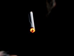 CU Shot of shadowed cigarette smoking in silhouette / Rome, Lazio, Italy Stock Footage