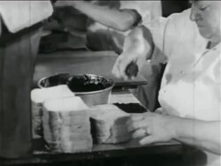 B/W 1934 close up woman making sandwiches in school lunch kitchen in WPA project / documentary Stock Footage