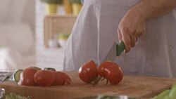 Chef cutting tomato in the kitchen Stock Footage