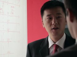 CU Two businessmen discussing and pointing on whiteboard / China Stock Footage
