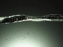 CU SLO MO Shot of small air bubble surfaces in water / United Kingdom Stock Footage
