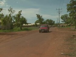 Red Toyota pick-up truck on dirt road, Maningrida Indigenous Community, NT, Australia Stock Footage