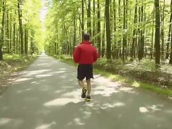HD SLOW MOTION: Man Jogging On A Country Road Stock Footage
