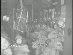 1950: KOREAN WAR: U.S. PARATROOPERS: VS Troop carrier airplanes flying overhead. INT VS United States 187th Airborne Paratrooper Regiment (aka 'Rakkasans') sitting in transport planes, soldiers jumping out. North Korea, 38th Parallel Instructional Video