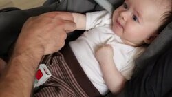 Securing baby in car seat Stock Footage