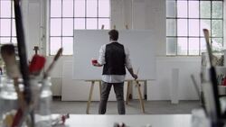 Artist starts painting on canvas Stock Footage