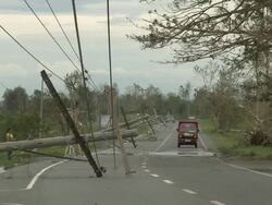 Downed power lines lie on road after Super Typhoon Megi or Juan, NE Luzon, Philippines Oct 2010 / AUDIO Stock Footage