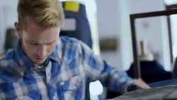 Modern clothing store employee counts stock and enters info on tablet Stock Footage