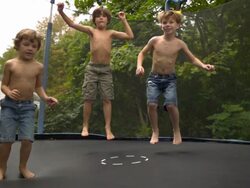 WS SLO MO shot of three Caucasian male children on trampoline, bouncing and tumbling / Stanford, Connecticut, United States  Stock Footage