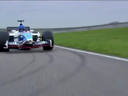 Low angle medium shot rear point of view Formula One race car riding around race track Stock Footage
