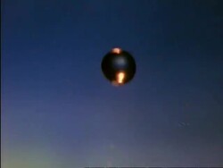 High Speed CU golden coloured water drop splashing into blue water, high angle Stock Footage