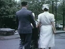 Nurse accompanies patient leaving hospital Stock Footage