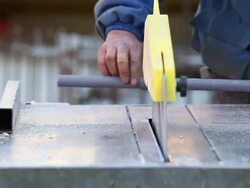 CU Worker Cutting Plastic Pipe at Construction Site Stock Footage