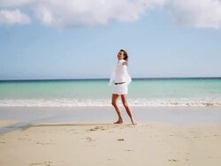 Woman spinning on beach Stock Footage