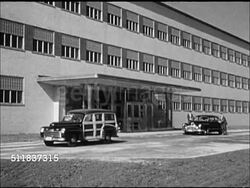 1947: RESEARCH BUILDING: XWS New modern design building BG, Chevrolet Woody station wagon passing car on new road FG. MS Modern office building w/ Chevrolet Woody pulling away. INT Labratory w/ male placing power in beaker. CU Filtering liquid. Instructional Video