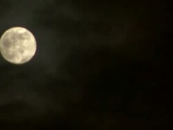 Low Angle static _ Clouds obscure a full moon as they drift by Stock Footage