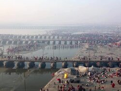 Pontoon bridges span shallow water as pilgrims cross and banks accommodate myriad activities. Kumbh Mela, India Stock Footage