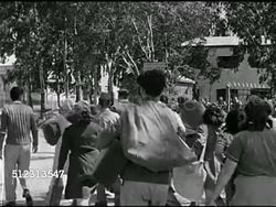 1945: PALESTINE: People walking from train. VS Jewish people walking, arriving at camp, being greeted w/ hugs & smiles from others. Instructional Video