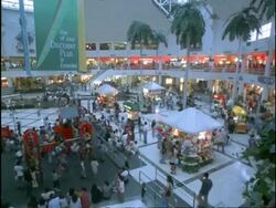 T/L MWA high angle, people moving up and down escalators at busy shopping mall, children playing in play area, makati commercial centre, manila, Philippines Stock Footage