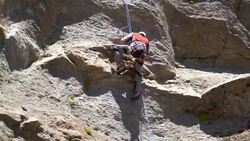 A rock climber falling and being saved by his rope. - Slow Motion Stock Footage