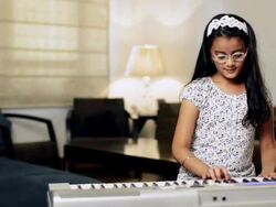 MS PAN Girl playing electric piano / India Stock Footage