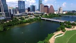 Very Low Perfect Shot Looking down on Town Lake Kayakers and Austin Texas Downtown Cityscape Skyline Stock Footage