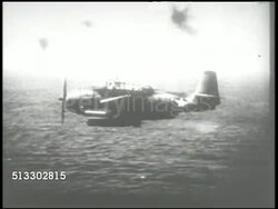 1942: GRUMMAN TBF TORPEDO BOMBER:  VS U.S. Navy Grumman TBF Avenger aircraft flying low over water, sea of Pacific Ocean, dropping & firing torpedo into water. WS Explosion & smoke. World War II, WWII, Pacific Front, Battle of Midway Island Instructional Video
