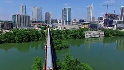 Train Crossing Bridge over Colorado River Austin Texas Downtown 4K Stock Footage
