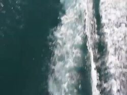 WS AERIAL TS View of wakeboarder and boat wake / geneva, switzerland  Stock Footage